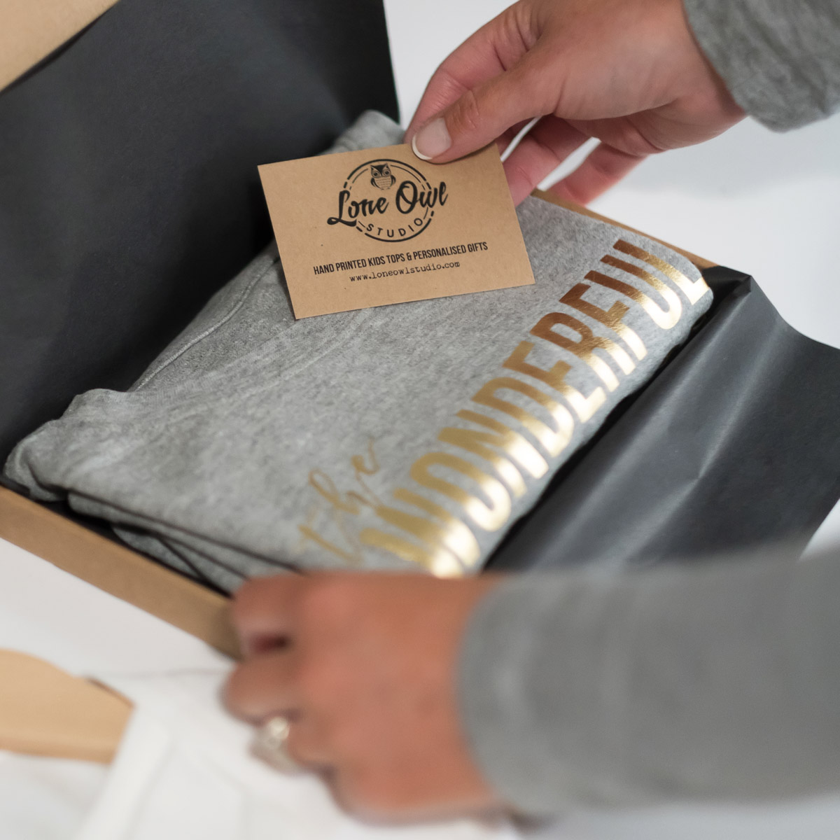 woman packaging tshirts for online orders captured by Spotlight Lane