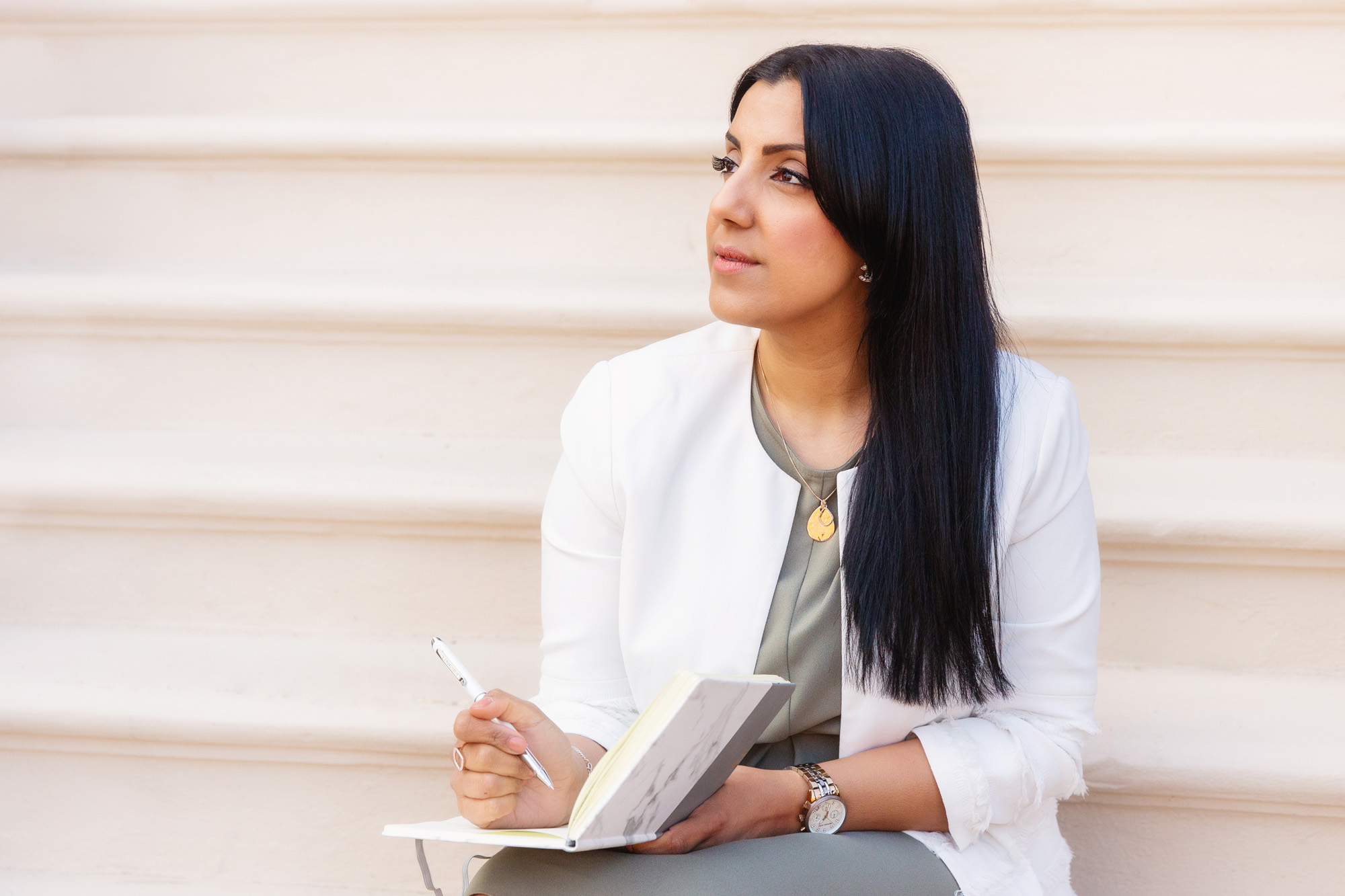 woman sitting on steps making notes on a personal branding photography session in Nottingham with Spotlight Lane